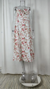 Detailed view of white floral dress featuring thin spaghetti straps and drawstring neckline