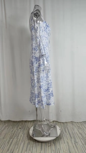 Detail of blue floral print dress with side slit and ruched bust design on mannequin