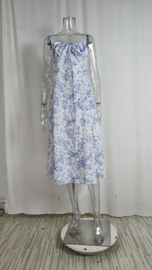Detail view of floral print dress featuring a drawstring neckline and blue floral patterns