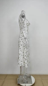 Side view of floral chiffon midi dress with puff sleeves and green leaf pattern detail