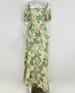 Detail of tropical leaf print and side cutout waist on this off-shoulder maxi dress
