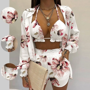 Three-piece floral beach set with bikini top, shorts, and long sleeve shirt cover-up