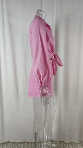 Side view of pink two-piece casual set with belted long sleeve shirt and matching shorts