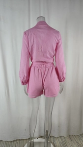 Back view of pink casual two-piece set featuring long sleeve top and elastic waist shorts