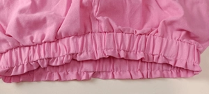 Detail of pink cotton-linen casual set showing elastic waistband and neat stitching