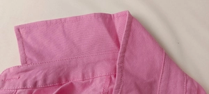 Detailed close-up of pink blouse collar with high-quality single-needle flat stitching
