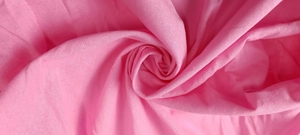 Close-up of bright pink cotton linen fabric with textured weave and natural drape