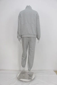 Detail view of the gray fleece texture and elastic cuffs on a casual two-piece tracksuit