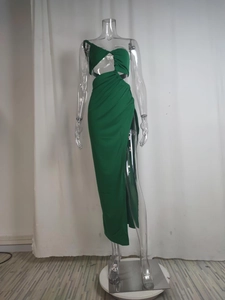 Detail of emerald green two-piece set featuring cutout crop top and high-slit maxi skirt