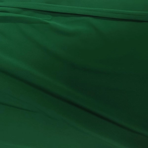 Detailed macro shot of dark green fabric texture showing seam lines and soft pleats