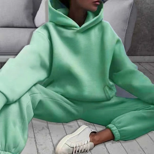 Detail view of mint green oversized hoodie and joggers tracksuit set on model