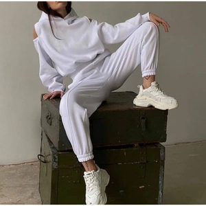 Close-up of white fleece tracksuit featuring shoulder cut-out hoodie and joggers