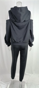 Detail view of black hoodie back cutout and pants with visible seam detailing