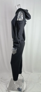 Side view of a black two-piece tracksuit with cold-shoulder hoodie and matching joggers