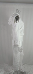 Detail view of white off-shoulder hooded tracksuit with ribbed cuffs on display