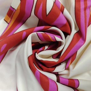 Detailed close-up of vibrant wavy print fabric showing smooth satin texture and drape