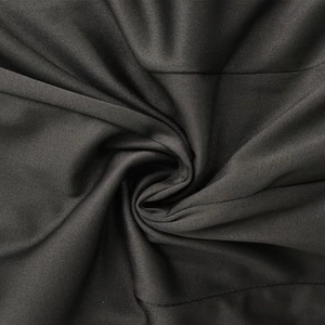Detailed close-up showing the smooth elastic black fabric texture of a bodycon dress