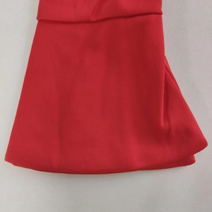 Detailed close-up showing the vibrant red fabric texture and hemline of this bodycon dress
