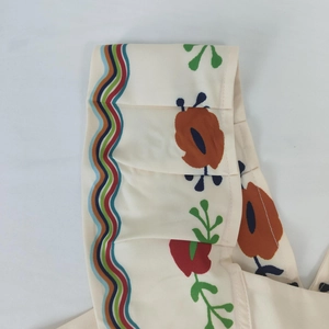 Detail of floral printed fabric with colorful wavy patterns and high-quality stitching
