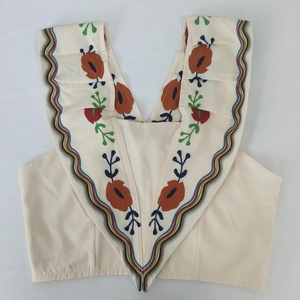 Detail of V-neckline with wavy trim and colorful floral embroidery on sleeveless top