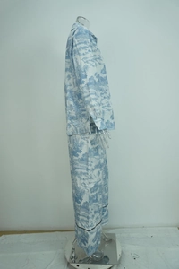 Detail of blue Toile de Jouy print pajamas with long sleeves and black piped cuffs