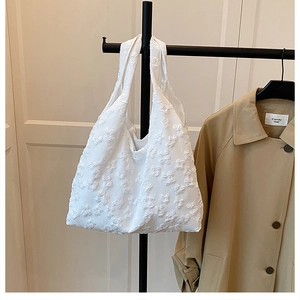 Detail of white seersucker tote bag featuring unique 3D bubble texture and soft fabric