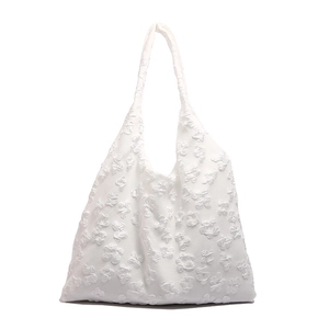 White textured tote bag with 3D floral pattern and spacious shoulder strap design