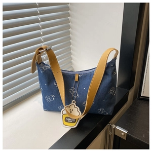 Blue denim underarm bag with yellow strap, white cartoon bear print and cupcake tag