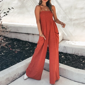 Brick red smocked wide leg jumpsuit with spaghetti straps and large side pockets