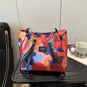 Fashionable tote bag with colorful abstract patterns and dual chain shoulder straps