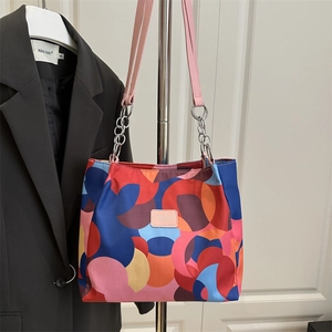 Modern colorful printed tote bag with pink leather strap and silver chain detail