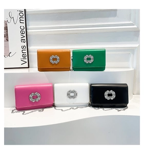 Detail of five luxury leather chain bags with rhinestone buckles in vibrant colors