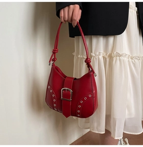 Detail of red Hobo bag with silver buckle and stylish knotted strap design