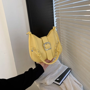 Minimalist bright yellow chain shoulder bag with silver buckle and eyelet hardware details