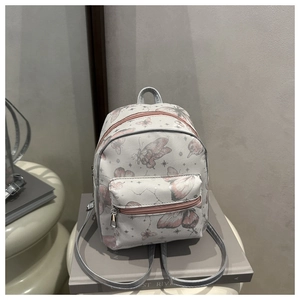 Detail of floral butterfly print and lychee texture on this mini white backpack