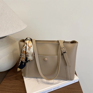 Elegant beige tote bag with decorative silk scarf and dual shoulder straps for women