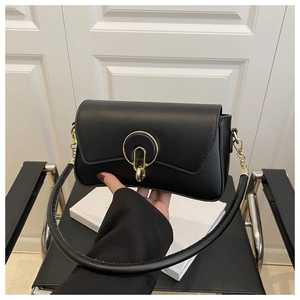 Detalle de bolso bandolera de cuero negro con hebilla en U dorada y correa de cadena de oro