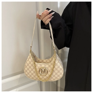 Detail of beige monogram shoulder bag with gold M logo and decorative thick chain strap