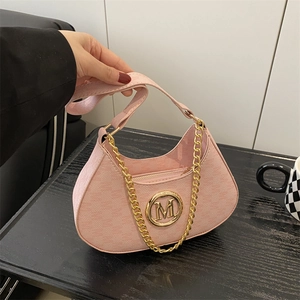 Chic pink crescent dumpling bag with golden M-logo charm and chain strap for summer