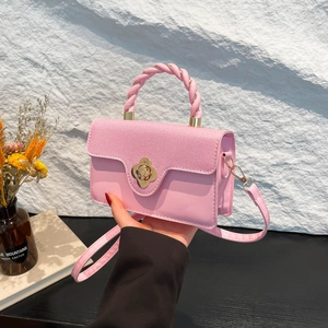 Pink crossbody bag with floral gold buckle and woven handle for summer fashion