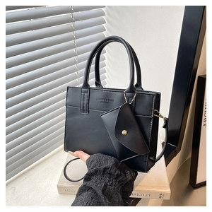Detail of black structured handbag with mini pouch and Fashion & Bags Leather text print