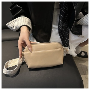Detail of beige faux leather square crossbody bag with stylish patterned wide shoulder strap