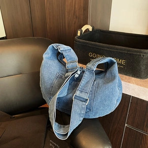 Minimalist large denim hobo shoulder bag with adjustable strap and vintage frayed edges