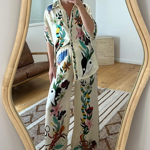 Silk-textured resort-style two-piece set with artistic floral and snake print patterns