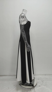 Detail view of the black and white contrast stitching on the elegant backless maxi dress