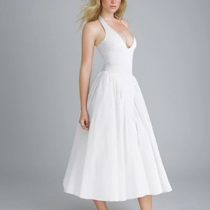Detailed view of white halter neck midi dress with deep V-neckline and A-line skirt