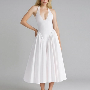 Elegant white halter neck pleated maxi dress with deep V-neck and flowing A-line silhouette