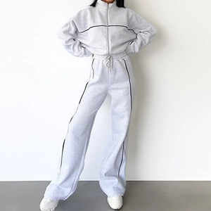 Detail view of the gray tracksuit showing black stripe accents and drawstring waist design