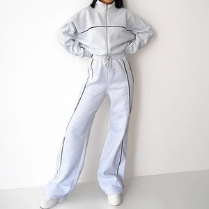 Detail of gray two-piece tracksuit with contrast side stripes and drawstring waistband