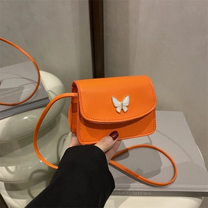 Vibrant orange mini crossbody bag with elegant white butterfly detail and slim shoulder strap